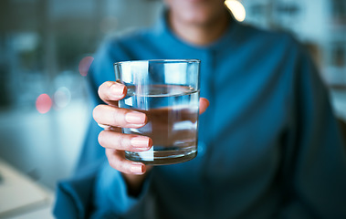 Image showing Water, glass and hand closeup in office, woman and giving for hydration, wellness or choice at finance company. Accountant, natural drink and zoom for nutrition, diet or detox for health in workplace