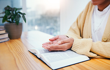 Image showing Bible, worship and open hands of woman in prayer, studying religion in home with Christian faith and knowledge of God. Reading, gospel and girl at table with holy book for spiritual praise and giving