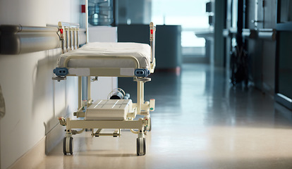 Image showing Healthcare, medicine and a bed in the hallway of a hospital after work, ready for an emergency or accident. Medical, wellness and service with a gurney in the empty corridor of a health clinic