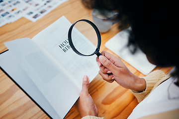 Image showing Bible, research and person with magnifying glass to study religion, holy spirit and the gospel of God to worship. Information, spiritual and closeup of Christian learning faith, hope and prayer