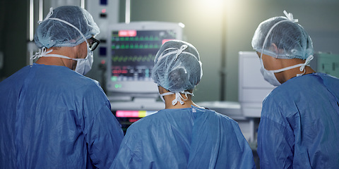 Image showing Teamwork, back or surgeon in surgery emergency procedure or healthcare operation in hospital. Night, monitor or doctors in face mask or collaboration helping in dark theatre room in medical clinic