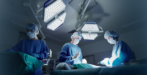 Image showing Doctor, team and patient in surgery, people or emergency operation in theatre at hospital. Nurse or medical professionals working together in teamwork for surgical healthcare, doctors or service