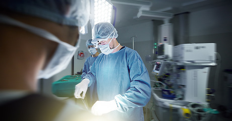 Image showing Medical, teamwork and doctors in a hospital for surgery together, working in theater to save a life. Healthcare, emergency and a surgeon team in the operating room of a clinic for an operation