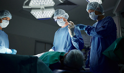 Image showing Teamwork, tools or doctors in surgery emergency procedure or healthcare operation in hospital at night. Giving, trust or surgeon in face mask or gloves helping in dark theatre room in medical clinic
