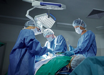 Image showing Collaboration, healthcare and doctors working on a surgery for medical treatment in a theatre room. Teamwork, career and professional surgeons doing an operation on a patient in a hospital or clinic.