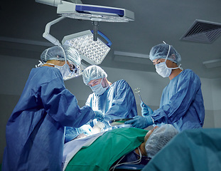 Image showing Teamwork, healthcare and doctors working on a surgery for medical treatment in a theatre room. Collaboration, career and professional surgeons doing an operation on a patient in a hospital or clinic.