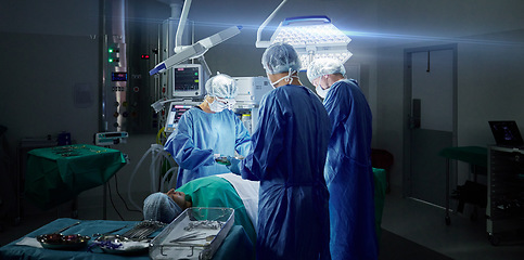Image showing Healthcare, teamwork and doctors in a hospital for an operation together, working in theater to save a life. Medical, emergency and a surgeon team in the operating room of a clinic for surgery