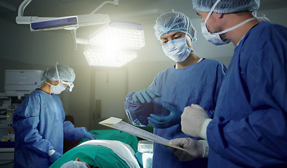 Image showing Collaboration, medical and doctors working on a surgery for healthcare treatment in a theatre room. Teamwork, career and professional surgeons doing an operation on a patient in a hospital or clinic.