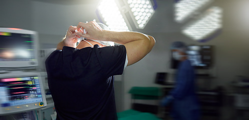 Image showing Surgeon tie mask in hospital, operation theatre or busy clinic for medial health or protection in emergency room. Back, doctor tying cap or surgery preparation in scrubs, safety ppe or uniform of man