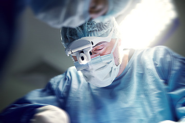 Image showing Headlight, healthcare and doctors in a hospital for surgery together, working in theater to save a life. Medical, teamwork and a surgeon in the operating room of a clinic for an operation closeup