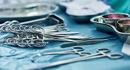 Image showing Background, surgery and metal tools in operating room for hospital assessment, healthcare service or emergency in medical theatre. Closeup, surgical equipment and scissors with forceps for operation