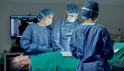 Image showing Teamwork, hospital and doctors working on a surgery for medical treatment in a theatre room. Collaboration, career and professional surgeons doing a healthcare operation on a patient in a clinic.