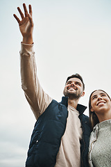 Image showing Vision, hiking and sky with a couple outdoor together for freedom, travel or adventure from below. Smile, hand and view with happy young people in nature to explore the wilderness for romance