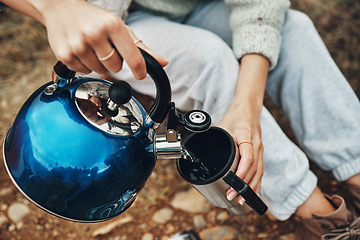 Image showing Camping, water and hands with mug for coffee in morning for trekking, adventure and freedom. Travel, nature and person with kettle for warm drink, beverage and tea on holiday, vacation and tourism