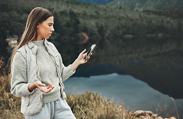 Image showing Phone, problem and confused woman hiking by lake in nature, travel or vacation. Smartphone, network error and person outdoor by river trekking, frustrated or bad signal connection, lost or app glitch