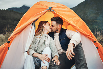 Image showing Couple, kiss and tent in camping on mountain for love, care or affection in nature together. Woman kissing man on camp site for romantic getaway, holiday vacation or weekend in outdoor bonding