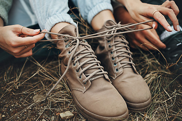 Image showing Shoes, hands tie shoelace and hiking, person outdoor in nature for travel and adventure, explore and zoom. Boots, camping with start or prepare for walk, trekking and journey with health and fitness