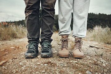 Image showing Feet, hiking and couple on mountain road with travel, holiday and adventure together outdoor. Shoes, journey and climbing in nature with walking, fitness and wellness for trekking with people