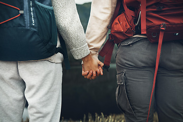 Image showing Couple, holding hands and backpack in nature for hiking, adventure or outdoor journey together. Rear view or closeup of hiker, people or backpacking in teamwork for trekking, motivation or support