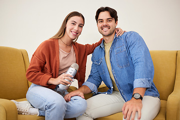 Image showing Portrait, microphone and podcast with a couple on a sofa in the living room of their home together. Smile, radio or talkshow with a happy young man and woman in their house for live streaming