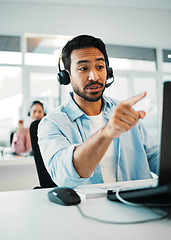 Image showing Asian man, call center and pointing in customer service, support or telemarketing at office. Businessman, consultant or agent with headphones in contact us for online advice or help at workplace