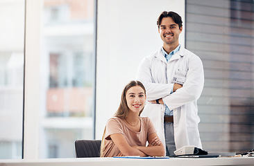Image showing Doctors, man and woman with arms crossed in portrait, smile and hospital office with leadership for medical job. Clinic staff, medic team and happy together for wellness with receptionist at desk