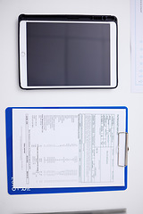 Image showing Above, table, tablet and healthcare report at a hospital with results for a chart and medical paperwork. Desk, clinic work and technology for communication with a document for insurance in office