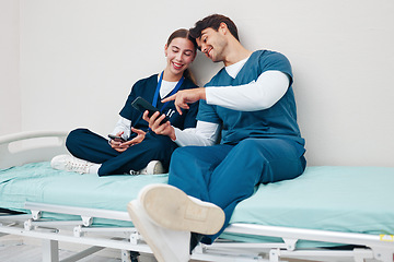 Image showing Doctor, student friends and break on phone on a hospital, healthcare and clinic bed with social media. Media, mobile and happy young people together with rest from medical and nursing internship