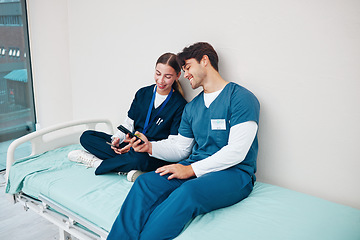 Image showing Doctor, students and break on phone on a hospital, healthcare and clinic bed with social media. Media, mobile and happy young people together with rest from medical and nursing internship on a app