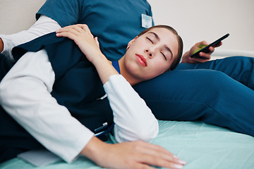 Image showing Tired, sleeping and nurses relax on break in hospital bed in clinic with friends, fatigue and support. Healthcare, typing on phone and woman with medical staff for rest, nap and exhausted in clinic