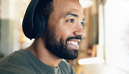 Image showing Face, smile and music with a man listening to audio in the living room of his home closeup. Headphones, radio and a happy young person having fun while streaming sound alone in his house to relax