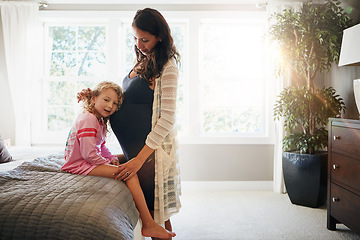 Image showing Bed, pregnant woman and kid listen to stomach, abdomen or girl hearing heartbeat, moving baby or family development. Mom, home bedroom and young child curious over pregnancy, maternity or life growth