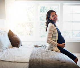 Image showing Home bed, happiness and woman pregnancy, massage stomach and mom happy for baby support, development or care. Expectation, bedroom flare and pregnant mother smile, love and relax on maternity leave