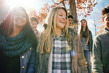 Image showing Teenager, walking and talking with friends in park, nature or social group outdoor together with diversity. Happy, teens or kids relax in fall with a joke, best friend or conversation in community