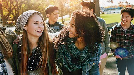 Image showing Teenager, walking and talking with friends in park, nature or social group outdoor together with funny conversation. Happy, teen and kids laugh at joke with best friend in community or relax in fall