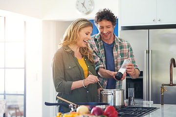 Image showing Love, salt and flavor with a couple cooking in the kitchen of their home together for health, diet or nutrition. Smile, food or recipe with a happy mature man and woman in their house for seasoning