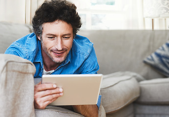 Image showing Man, relax and tablet internet on sofa for digital contact, social media or movie app. Male person, streaming film and online shop connection or connectivity fun for comfort, weekend joy in house