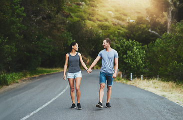 Image showing Road, love or happy couple holding hands or walking on date with smile, care for romance or adventure. Peace, freedom or man with woman on holiday vacation together for bond, support or wellness