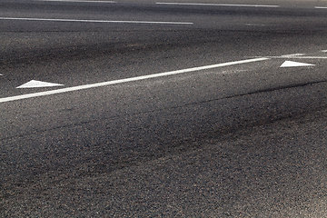 Image showing close-up of an asphalt road with white road markings