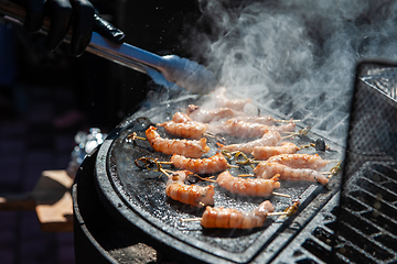 Image showing A professional cook prepares shrimps