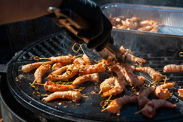 Image showing A professional cook prepares shrimps
