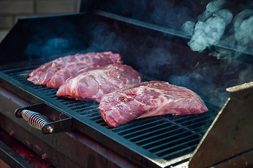 Image showing Pork meat steaks on the grill