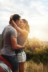 Image showing Road trip, love or couple kiss in park for date, support or care on a summer romance or adventure. Relax, hug or man with woman on outdoor holiday vacation together for bond, travel or breka