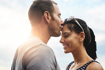 Image showing Forehead, love or couple kiss in park for date, wellness or care on summer romance or adventure. Support, smile or man with happy woman on outdoor holiday vacation together to bond, travel or relax