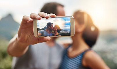 Image showing Phone screen, selfie and couple kiss in nature outdoor on summer vacation together. Smartphone, romance and picture of man and woman in countryside for connection, memory of love and relationship