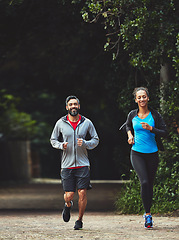 Image showing Couple, running in park for fitness and health outdoor, support and training for marathon with cardio. Runner, athlete and sport with people in nature, challenge and exercise with workout for race