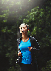 Image showing Woman in park, running and fitness in nature, exercise and training for marathon with athlete and sports. Runner, speed and challenge with workout, cardio outdoor for health and wellness with energy