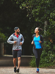 Image showing Couple, running in park for exercise and health outdoor, support and training for marathon with cardio. Runner, athlete and sport with people in nature, challenge and fitness with workout for race