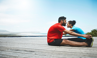 Image showing Couple, stretching and legs in exercise at beach to start fitness, training or outdoor with blue sky mockup. Workout, preparation and people together for sports, performance and feet on a deck