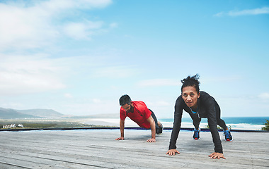 Image showing Couple, beach and push ups outdoor, fitness and muscle training with strong people and bodybuilding. Power, challenge and weights with exercise and workout together in nature for bonding and health